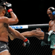 Kamaru Usman, right, kicks Tyron Woodley during a welterweight mixed martial arts title fight at UFC 235, Saturday, March 2, 2019, in Las Vegas.